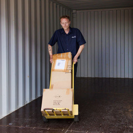 Aylesford Self Storage staff moving boxes from storage unit